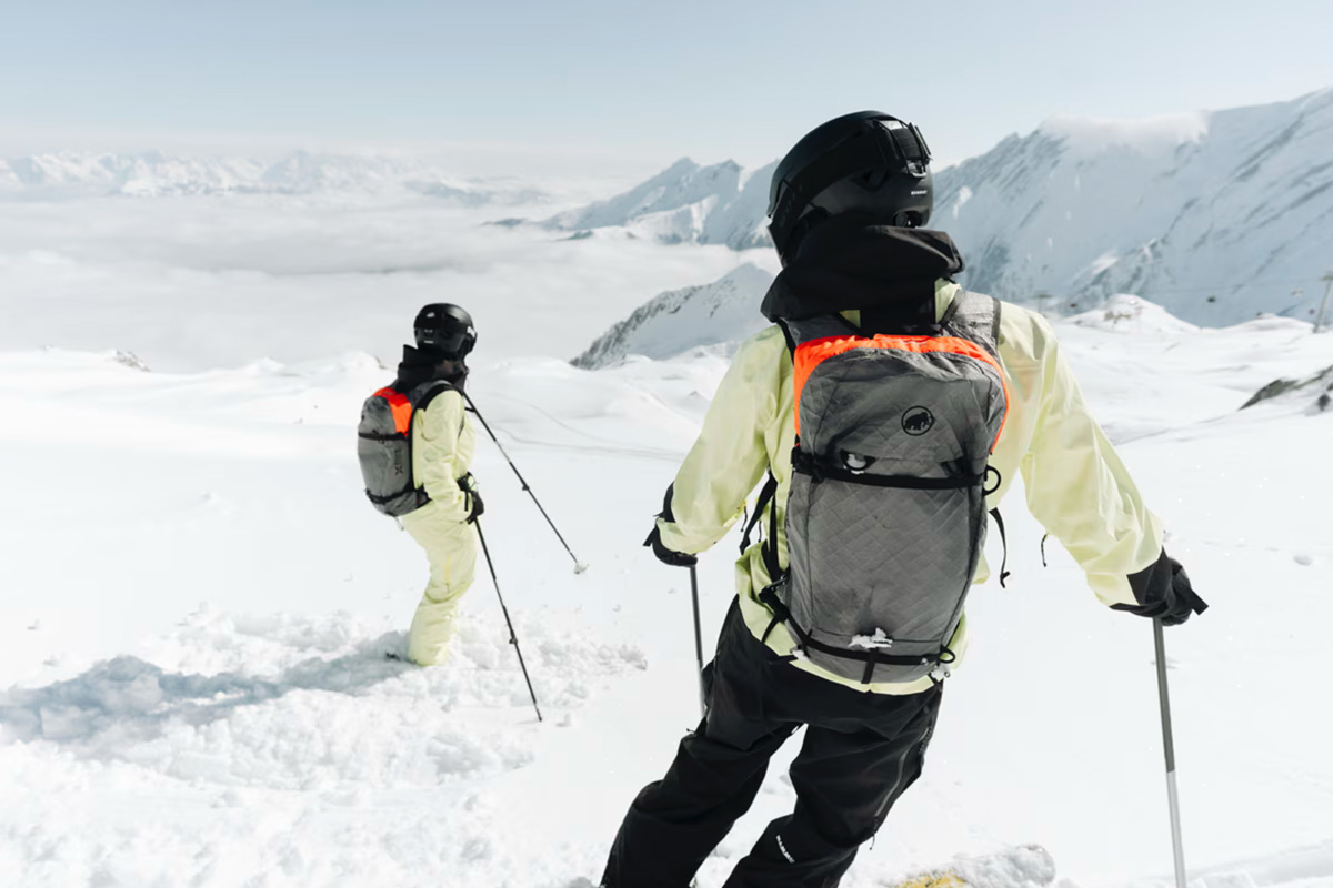 Backcountry skier equipped with Mammut Eiger Free 20 Airbag Backpack navigating steep alpine terrain in perfect winter conditions.